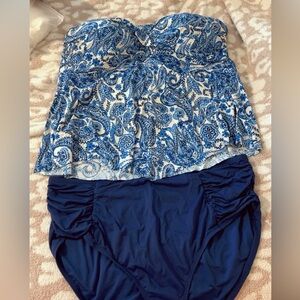 Two bathing suit tankini tops with one pair navy bottoms that go with both tops.